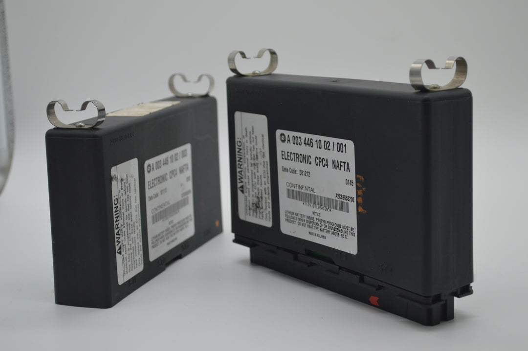 Dual CPC4 modules for Freightliner trucks positioned side by side, showing detailed Continental manufacturing labels and module casing.