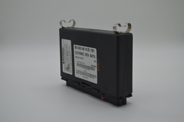 Close-up front angle view of Freightliner CPC4 module with part number A0034461002, showing label and mounting clips