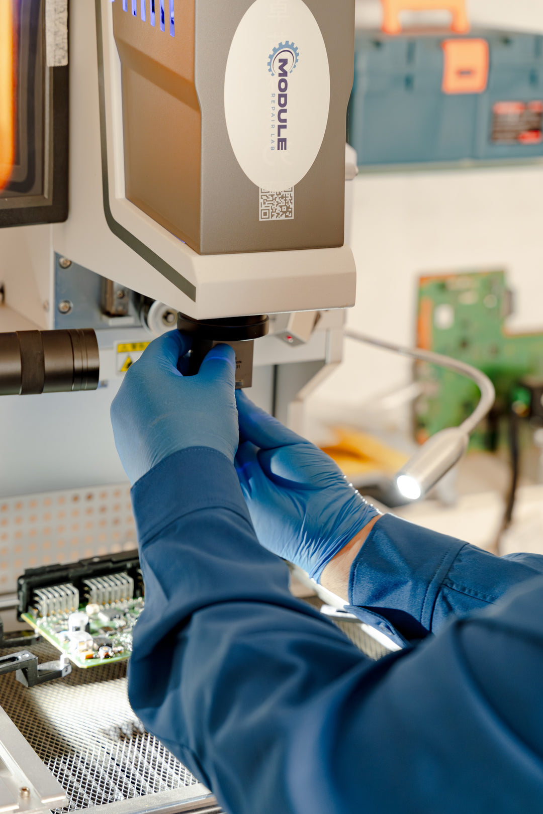 Module Repair Lab with  blue gloves using a BGA reballing machine during a cpc4 repair.
