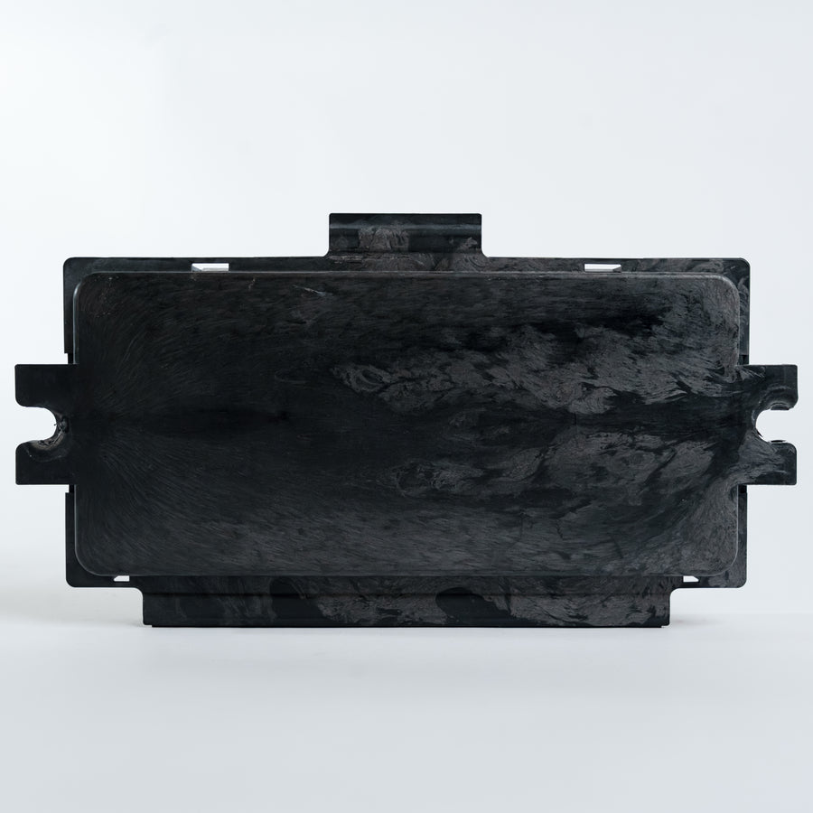 BMW FRM footwell module rear housing view showing sealed enclosure and mounting tabs