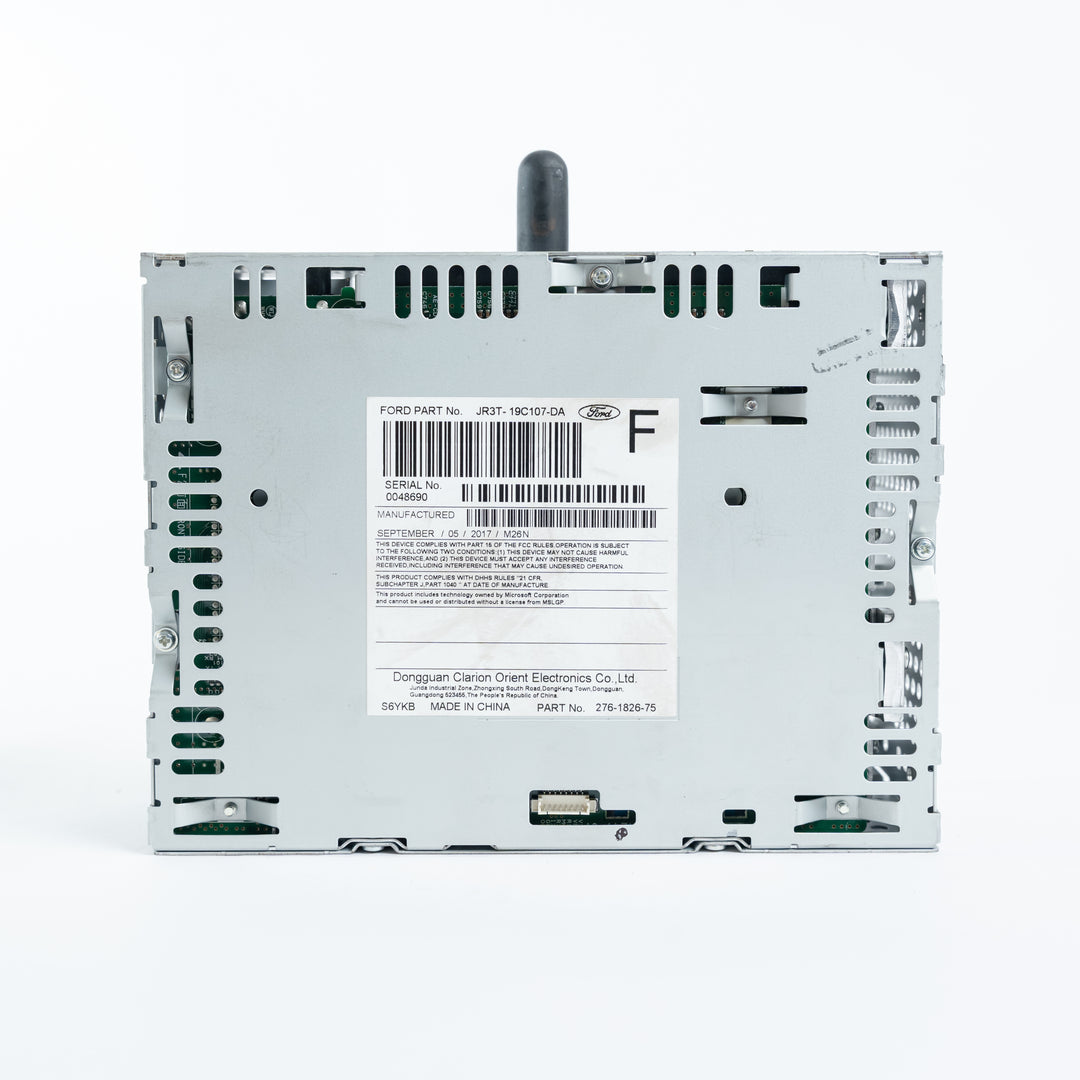 Rear view of Ford ACM Audio Control Module showing JR3T-19C107-DA label, barcode, connectors, and metal chassis for repair service at Module Repair Lab