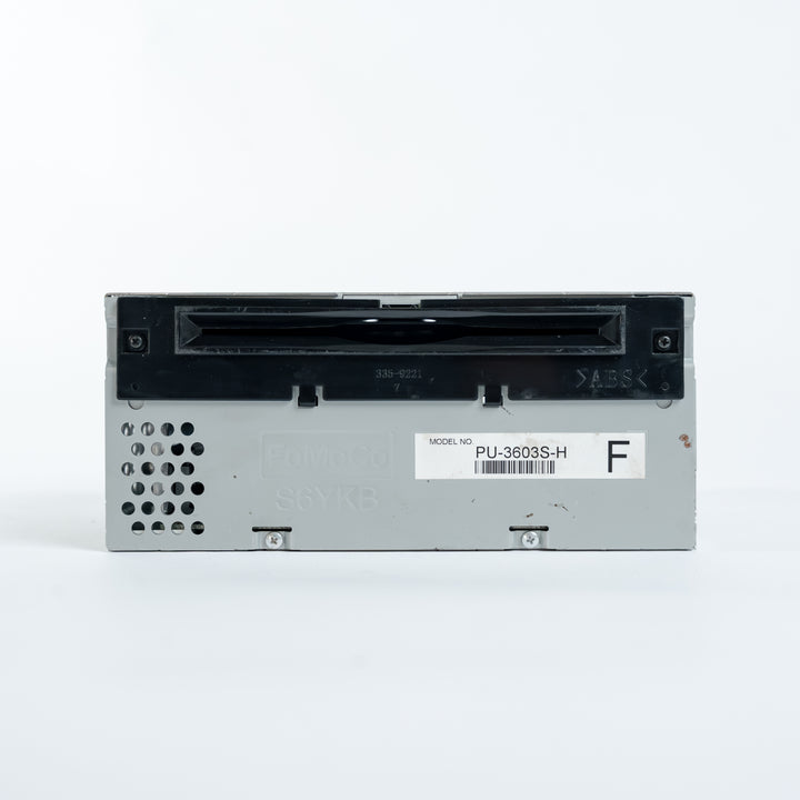 Front panel of Ford ACM radio head unit model PU-3603S-H with CD slot, ventilation openings, and FoMoCo markings for professional module repair