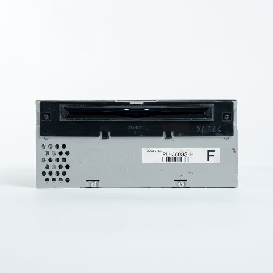 Front panel of Ford ACM radio head unit model PU-3603S-H with CD slot, ventilation openings, and FoMoCo markings for professional module repair