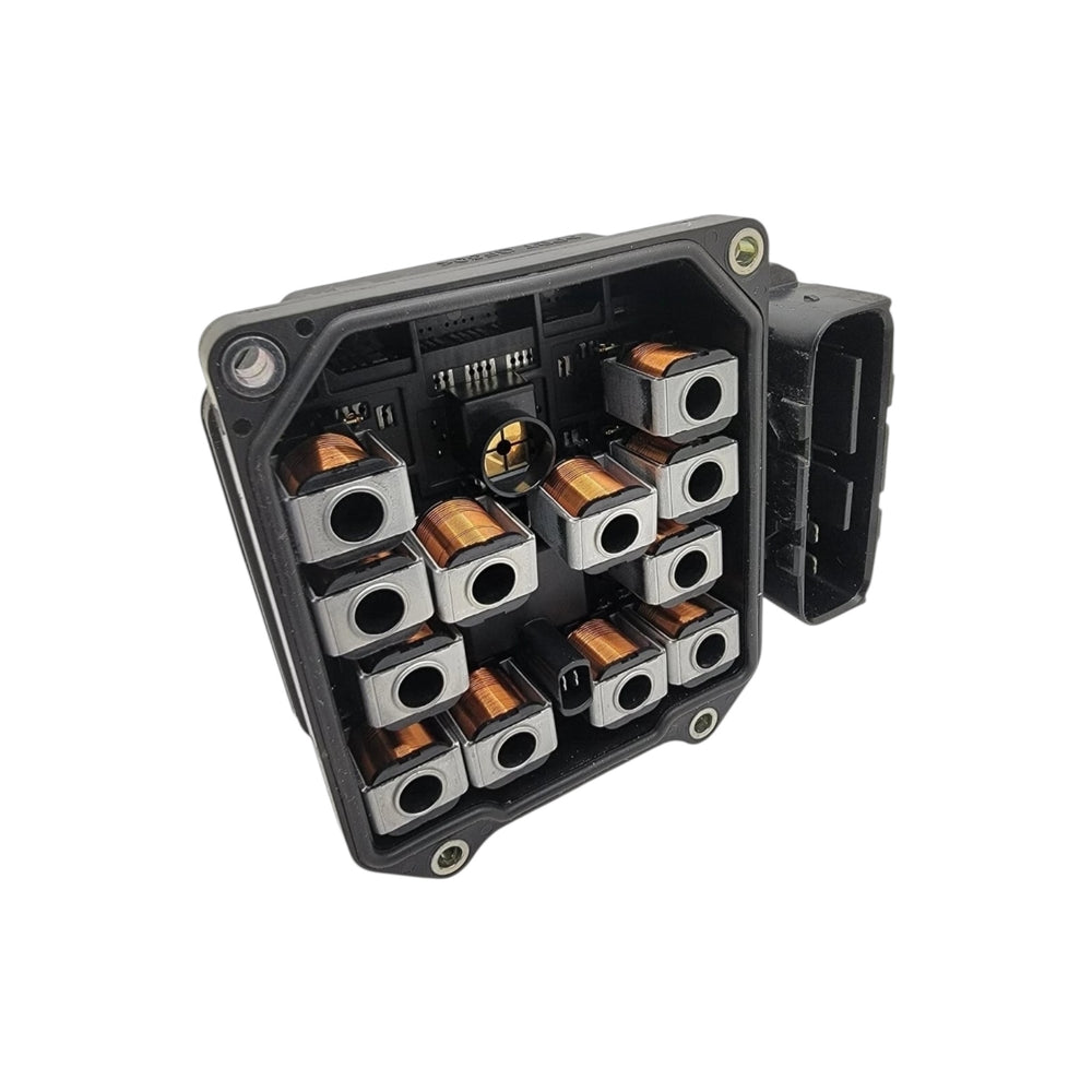 Close-up of Honda ABS module hydraulic block with brake line ports